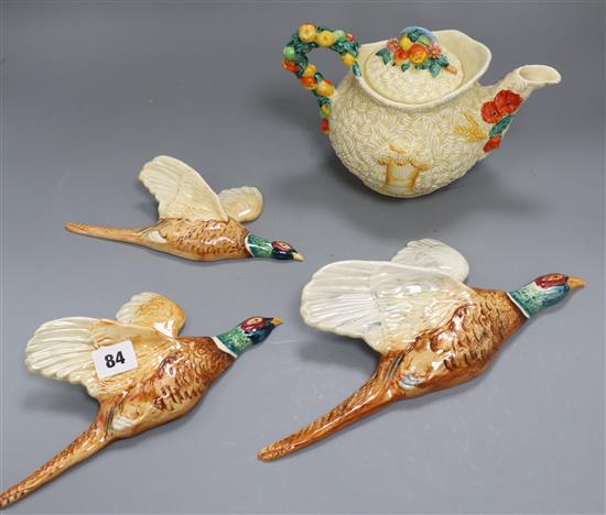 A Clarice Cliff harvest pattern teapot and three Beswick flying pheasants